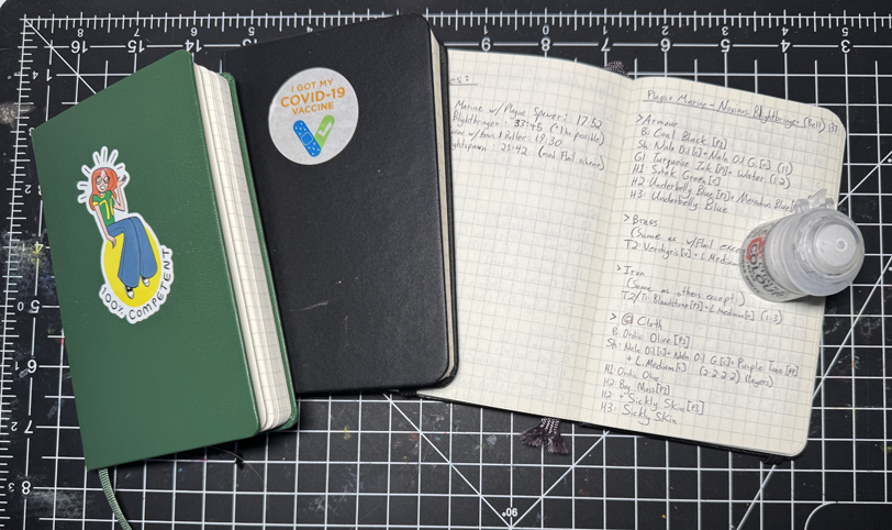 three mini notebooks with grid paper
